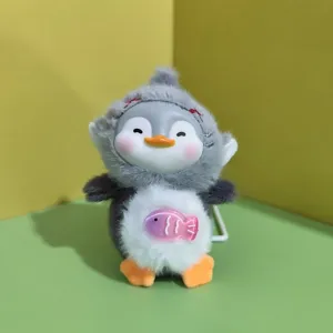 Close-up detail of cute penguin plush pendant, soft plush body and vinyl face design.
