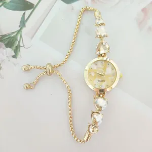 Gold-tone heart crystal quartz watch detail, adjustable pull chain strap, elegant dial design.