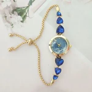 Fashion women quartz watch with blue heart crystal stones and adjustable gold chain strap.