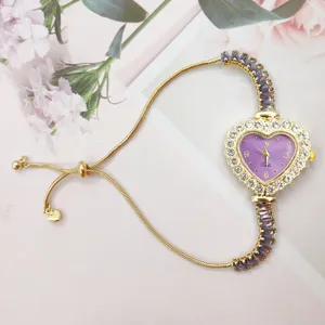 Heart-shaped purple dial rhinestone ladies watch detail, elegant adjustable pull chain.