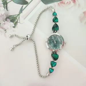 Fashion women quartz watch with green heart gems and adjustable silver sliding bracelet.