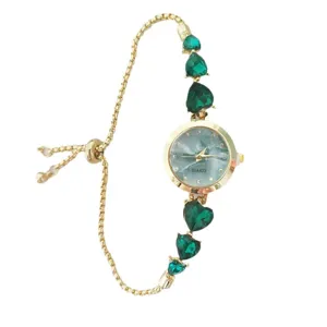 Detailed view of the women fashion quartz watch featuring green heart crystal and gold chain.