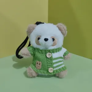Cute plush panda pendant detail, wearing green knit sweater with rabbit patch and buttons.