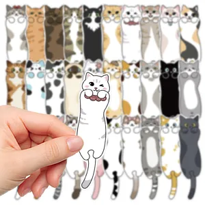 Close-up detail of a cute cat bookmark held by hand, showcasing the charming cartoon cat design.
