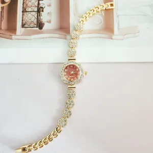 Elegant rhinestone flower women quartz watch, gold metal bracelet with sparkling crystal links.