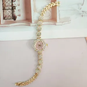 Women's rhinestone quartz watch with flower case and sparkling crystal bracelet.