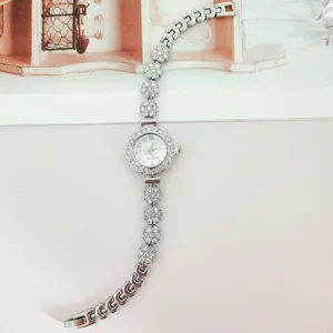 Silver rhinestone floral quartz wristwatch for women, sparkly crystal link bracelet watch.
