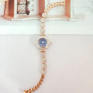 Elegant rose gold rhinestone quartz watch with floral dial and glittering bracelet for women.