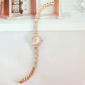 Rose gold rhinestone quartz watch for women, stylish floral link bracelet design, elegant gift.
