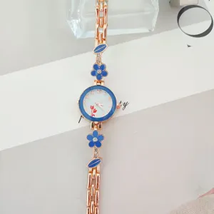 Elegant rose gold women quartz watch with blue flower bracelet design for ladies fashion.