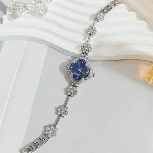 Detailed shot of the crystal clover watch dial, showing sparkling rhinestones and elegant links.