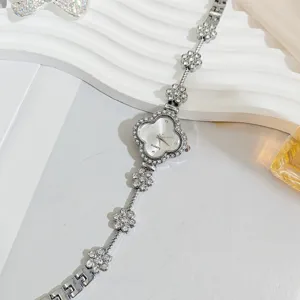 Detailed view of the luxury silver rhinestone four-leaf clover quartz bracelet watch for women.
