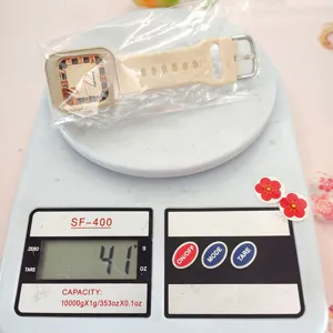 Detail shot showing a square silicone quartz watch on a scale, weighing 41g precisely.