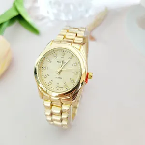 Gold rhinestone quartz watch detail view, elegant metal strap and sparkly dial markers.