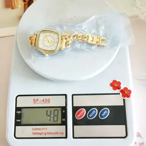 Vista detallada del elegante reloj de cuarzo dorado con pedrería en báscula de 48g.