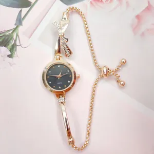 Elegant women quartz watch with bow rhinestone design, fashionable gold chain bracelet timepiece.