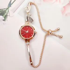 Elegant women quartz watch featuring red dial, sparkling rhinestone bow and adjustable bracelet chain.