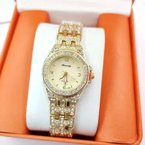 Detailed view of the women luxury rhinestone quartz watch with gold steel strap and sparkly dial.