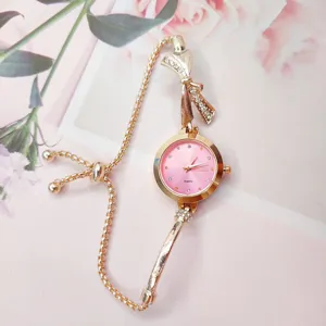 Elegant women's quartz watch with sparkling rhinestone bow and stylish pink dial bracelet.