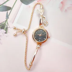 Elegant women's quartz bracelet watch with sparkling rhinestone bow and adjustable chain.