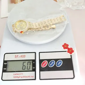 Detailed view of women luxury gold rhinestone quartz watch with steel strap on scale.