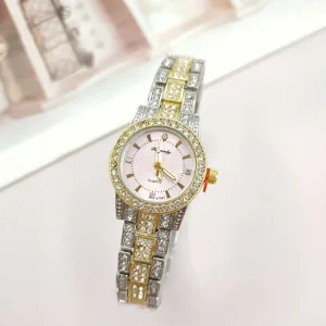 Close-up detail of women quartz watch with sparkling rhinestones, pink dial and metallic steel band.