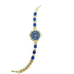 Luxus Damen Quarzuhr mit blauen Tropfensteinen und goldenem Armband stilvolles Design