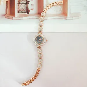 Elegant rose gold rhinestone women quartz watch featuring floral dial and dazzling bracelet.