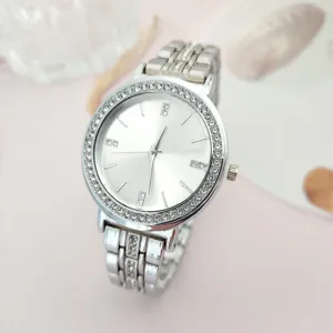 Silver rhinestone quartz watch with shimmering crystal bezel and elegant steel band detail.