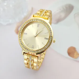 Detailed close-up of a luxury gold rhinestone quartz watch showcasing exquisite dial details.