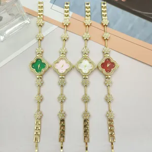 Clover quartz watch detail showcasing four-leaf clover dial, rhinestone bracelet, and gold finish.
