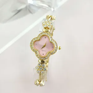Elegant gold quartz watch for women featuring pink clover dial and sparkling rhinestones.