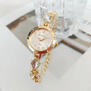 Elegant women gold quartz watch with sparkling crystal bracelet, luxury numerical dial detail.