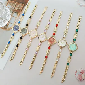 Elegant women's quartz watch bracelet set with colorful gemstones and clear dial numbers.