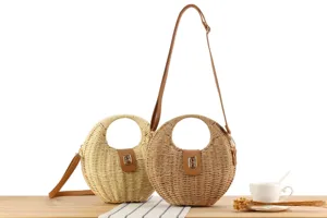 Handwoven straw shoulder bag detail shot, natural round rattan crossbody purse with leather flap.