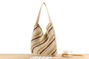 Handmade woven straw shoulder bag with diagonal colorful stripes, casual beach vacation style.