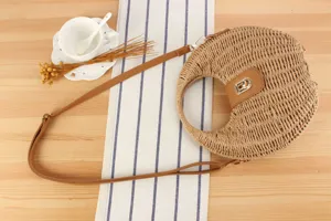 Handcrafted straw shoulder bag detail shot, daily casual half-moon woven purse for women.
