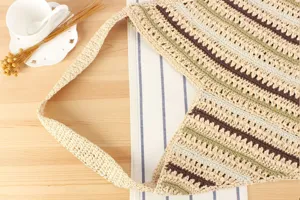 Handwoven diagonal striped shoulder bag detail view, straw knit casual beach vacation bag.