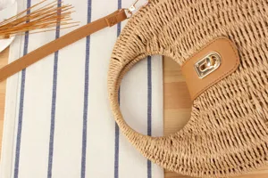 Woven straw handbag with PU leather clasp and strap, detailed beach casual bag.