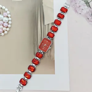 Women's elegant red crystal quartz watch with rectangular dial and silver link bracelet.