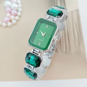 Green crystal quartz watch detail showing elegant square emerald dial and sparkling gem bracelet.