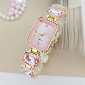 Pink crystal quartz watch detail shot, elegant women's gemstone wristwatch closeup view.