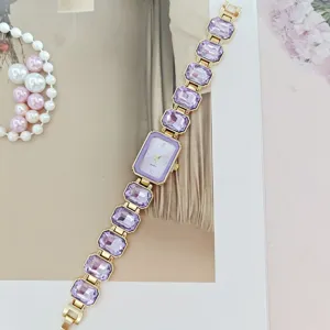 Elegant purple crystal quartz watch for women with gold-tone rectangular linked chain bracelet.