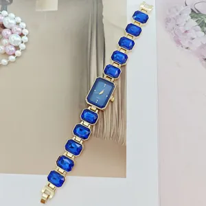 Exquisite crystal quartz watch with blue rectangular dial and sparkly gem bracelet fashion accessory.