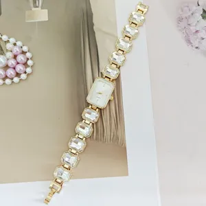 Elegant gold quartz watch for women featuring sparkling crystal rhinestone chain strap.
