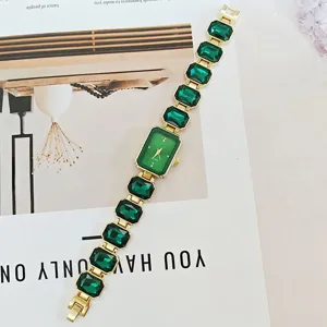 Close-up detail of luxury green crystal quartz watch with elegant gemstone bracelet style.