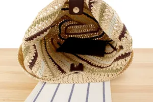 Hand-woven diagonal stripe straw shoulder bag interior detail view, perfect for summer vacation.