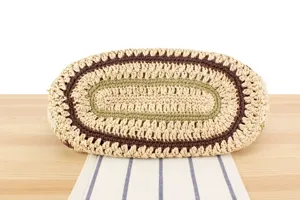Handmade woven paper rope straw shoulder bag bottom detail showcasing multi-color concentric rings.