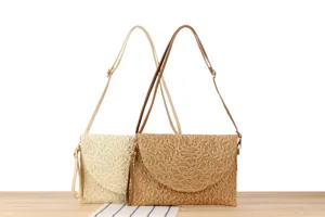 Detailed shot of woven straw shoulder bag, featuring natural texture and chic design.
