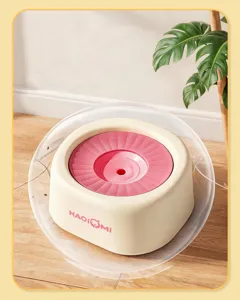 Closeup view of a pet floating water bowl with a pink disk and cream base for clean drinking.